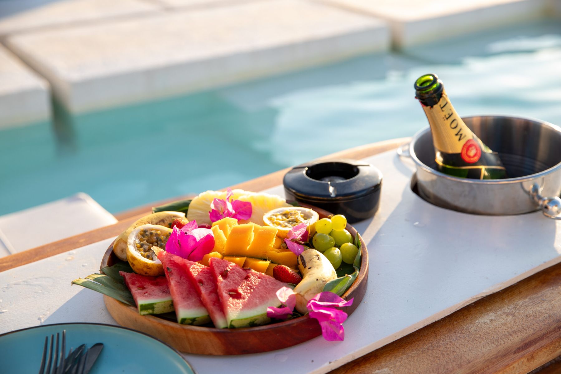 Tropical fruit platter and champagne bucket served poolside